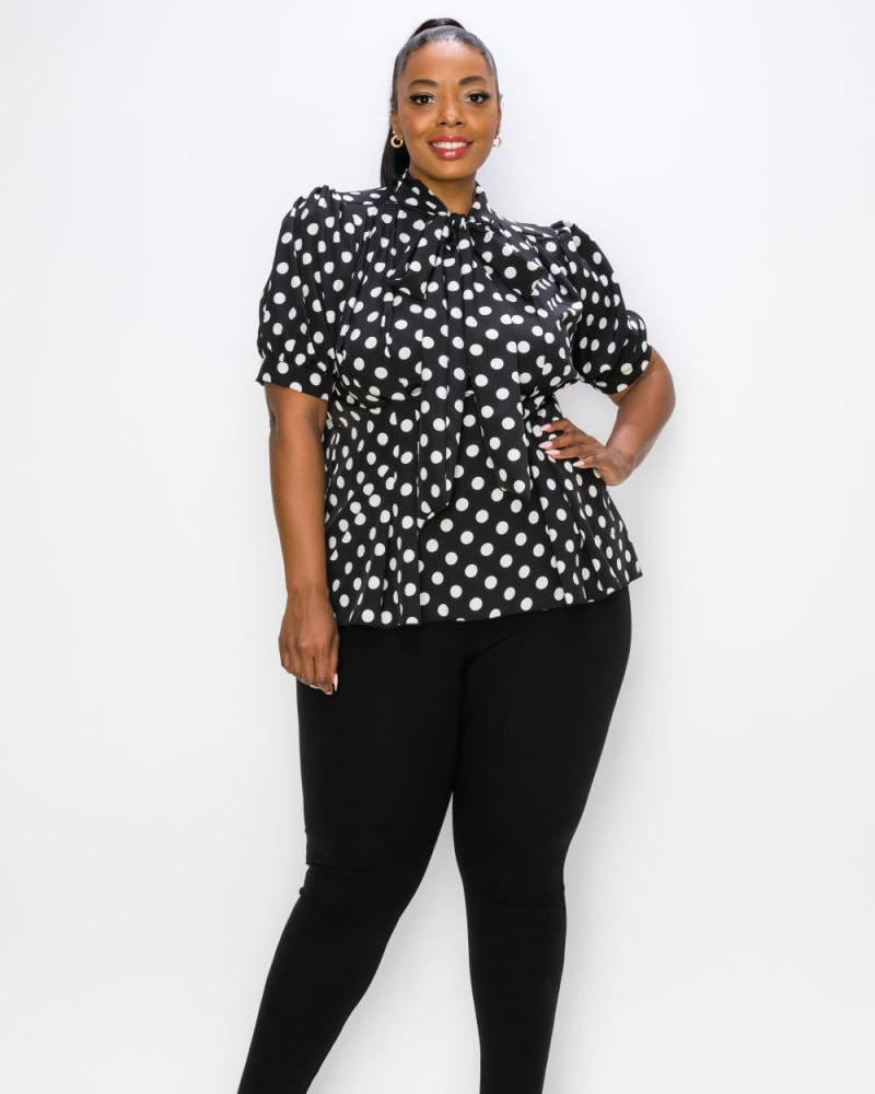 Front of a model wearing a size 1X Minnie Polka Dot Tie Neck Blouse in Black/Ivory by L I V D. | dia_product_style_image_id:241364